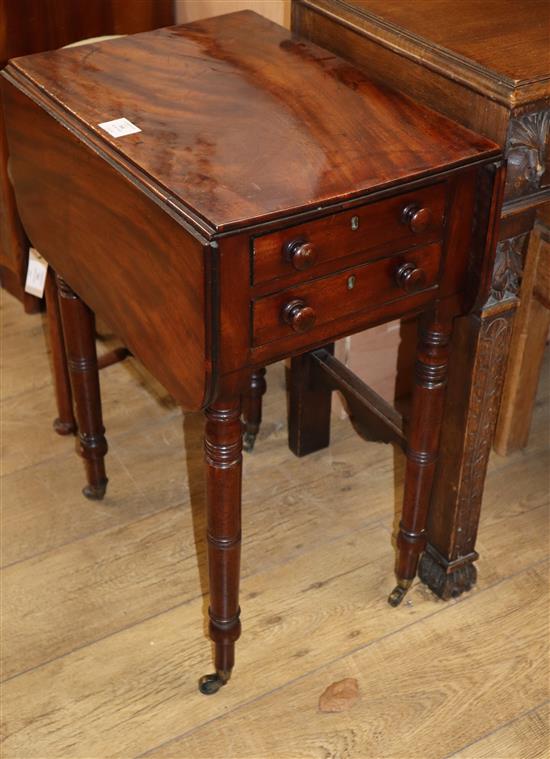 An early Victorian mahogany work table, with double flap top and two end drawers, on turned and tapering legs